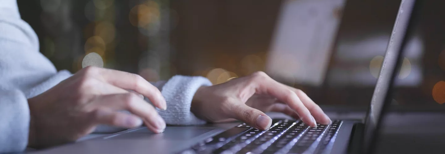 Typing on a laptop